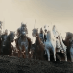 "Troopers of Rohan stand united on a hill, ready for battle, overlooking Helm's Deep."